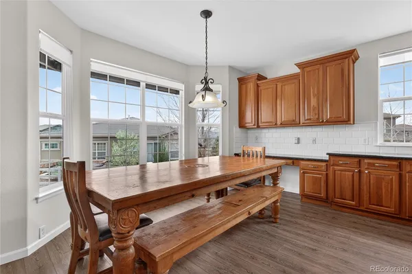 a kitchen with kitchen island a wooden table chairs and granite counter tops