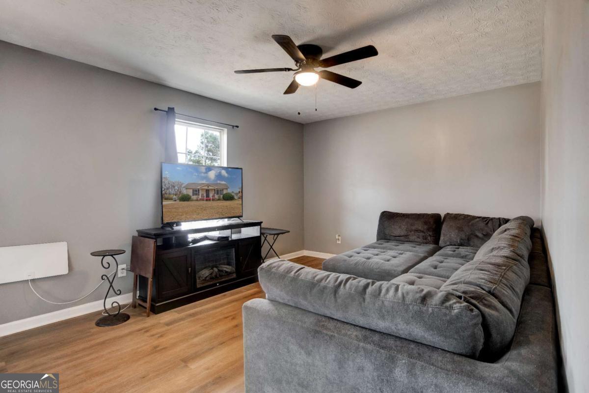 665 Caney Branch Road Lavonia, GA 30553 - Photo 13 of 26 a bedroom with a bed and a ceiling fan