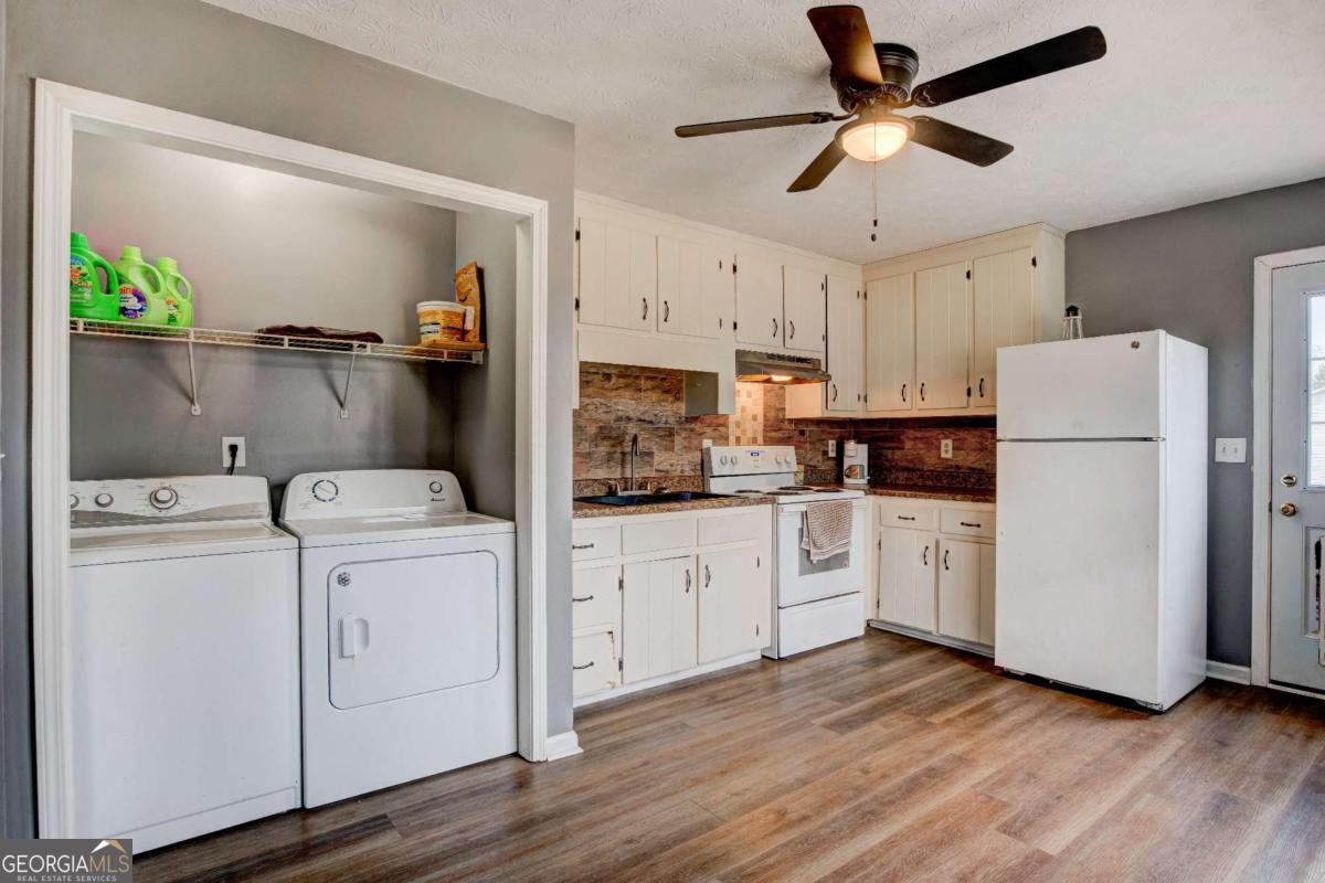665 Caney Branch Road Lavonia, GA 30553 - Photo 15 of 26 a kitchen with cabinets stainless steel appliances and wooden floor