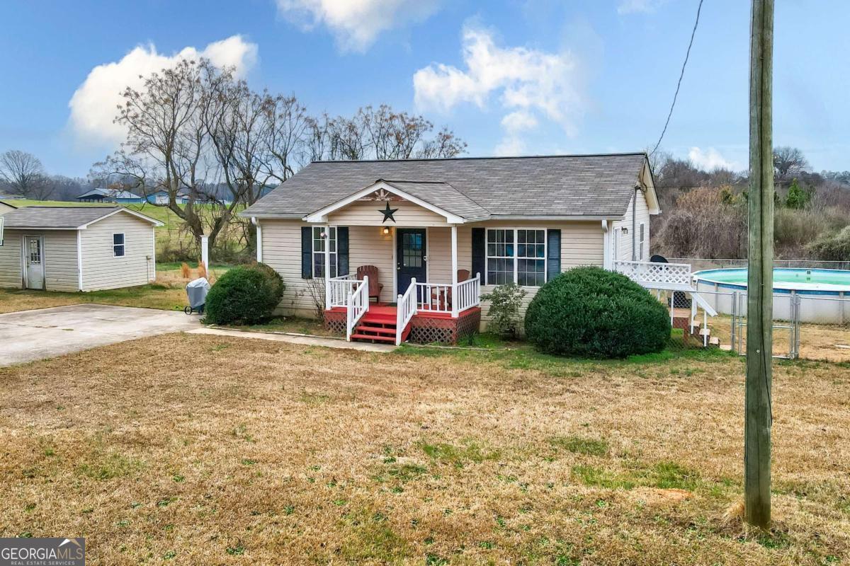 665 Caney Branch Road Lavonia, GA 30553 - Photo 2 of 26 a view of a house with a yard and large tree