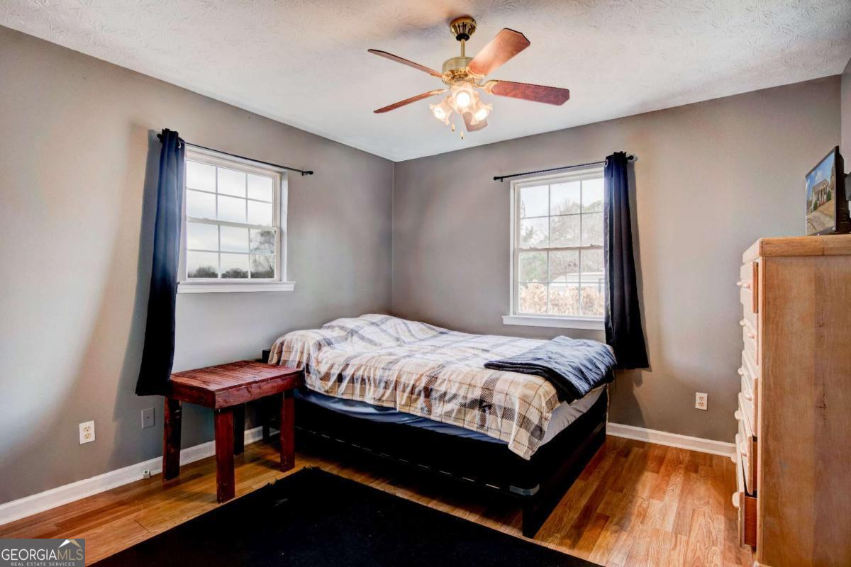 665 Caney Branch Road Lavonia, GA 30553 - Photo 22 of 26 a bedroom with a bed desk and a window