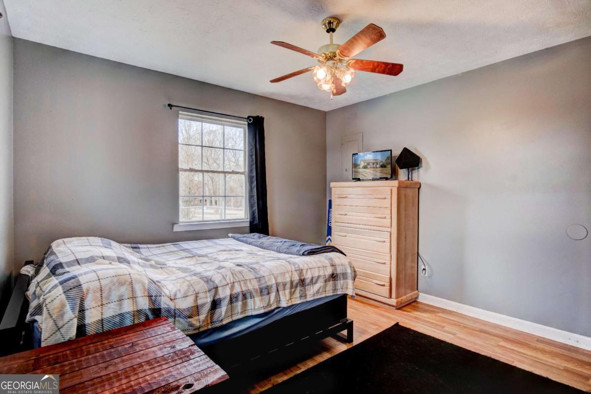 665 Caney Branch Road Lavonia, GA 30553 - Photo 23 of 26 a bedroom with a bed and a chandelier