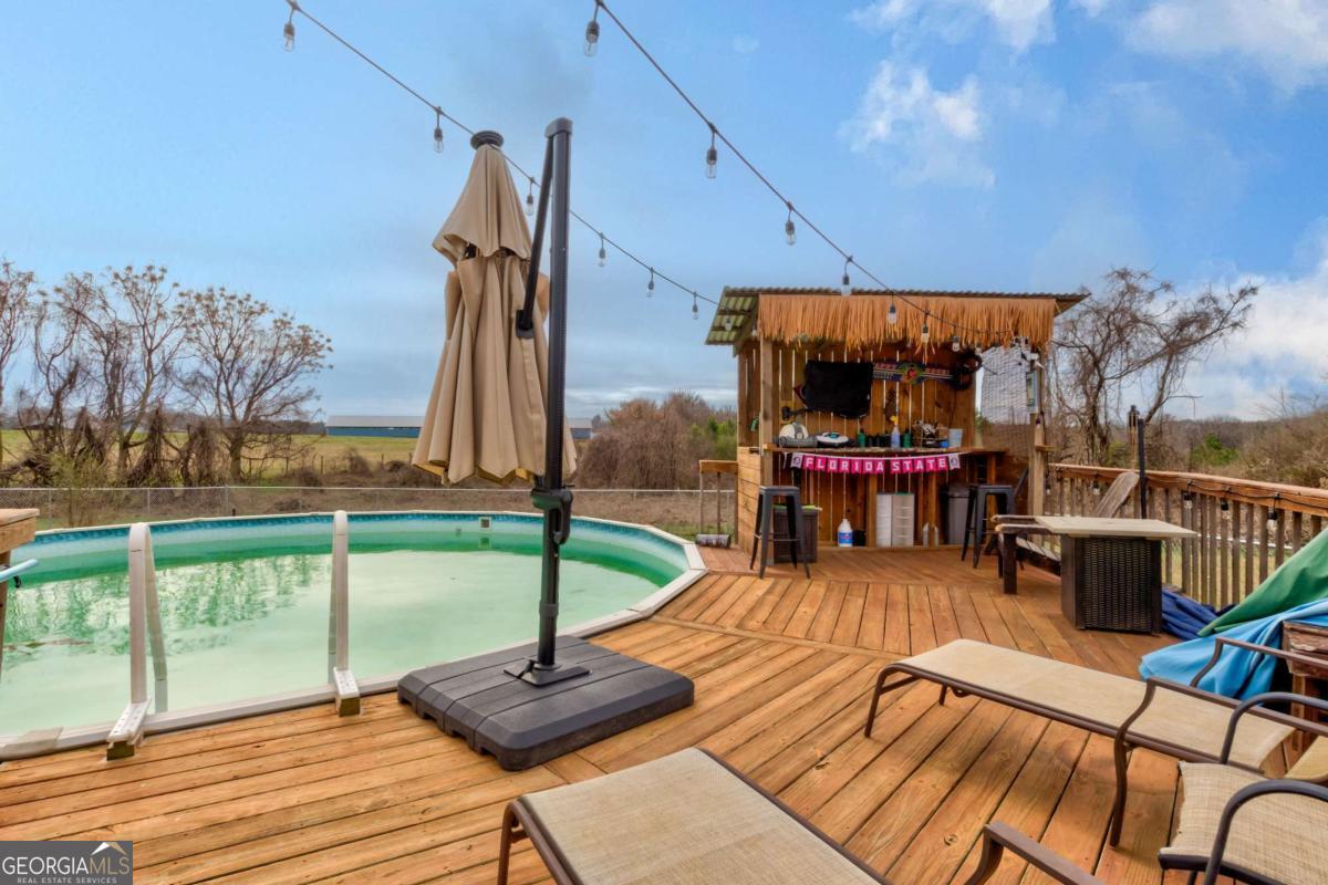 665 Caney Branch Road Lavonia, GA 30553 - Photo 9 of 26 a view of a swimming pool with a patio and a yard