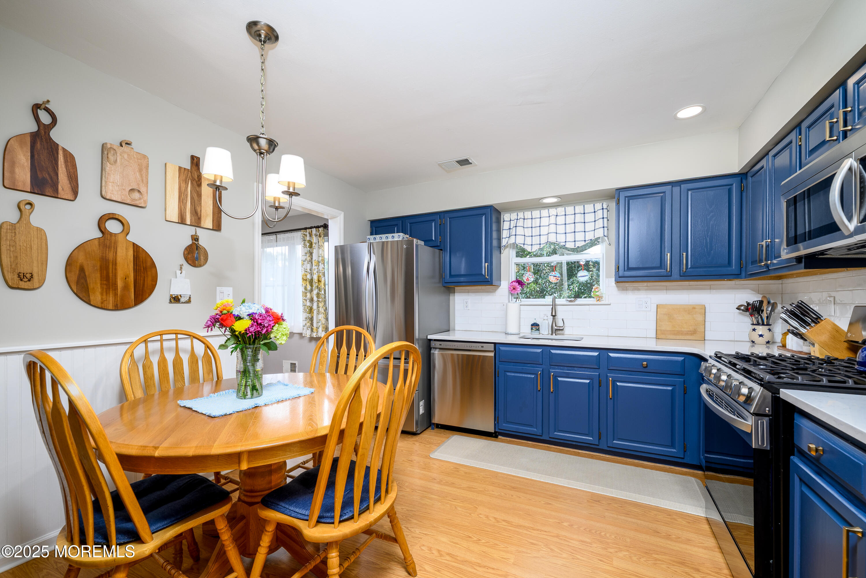 18 Fella Street Howell, NJ 07731 - Photo 10 of 35 a kitchen with granite countertop a dining table chairs and white cabinets