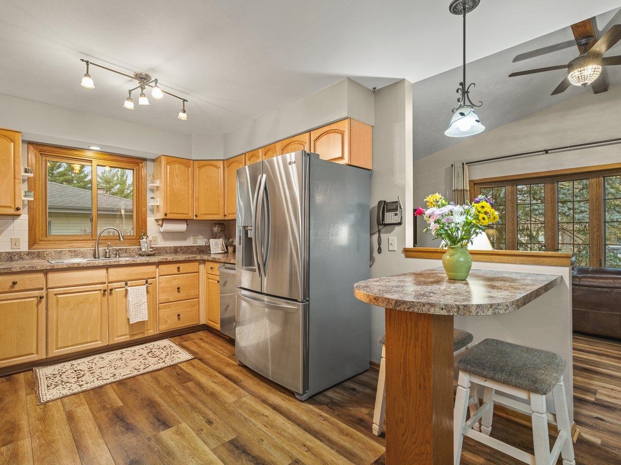 1816 Post Road Beloit, WI 53511 - Photo 13 of 42 a kitchen with stainless steel appliances granite countertop a refrigerator a sink dishwasher a stove and white cabinets with wooden floor