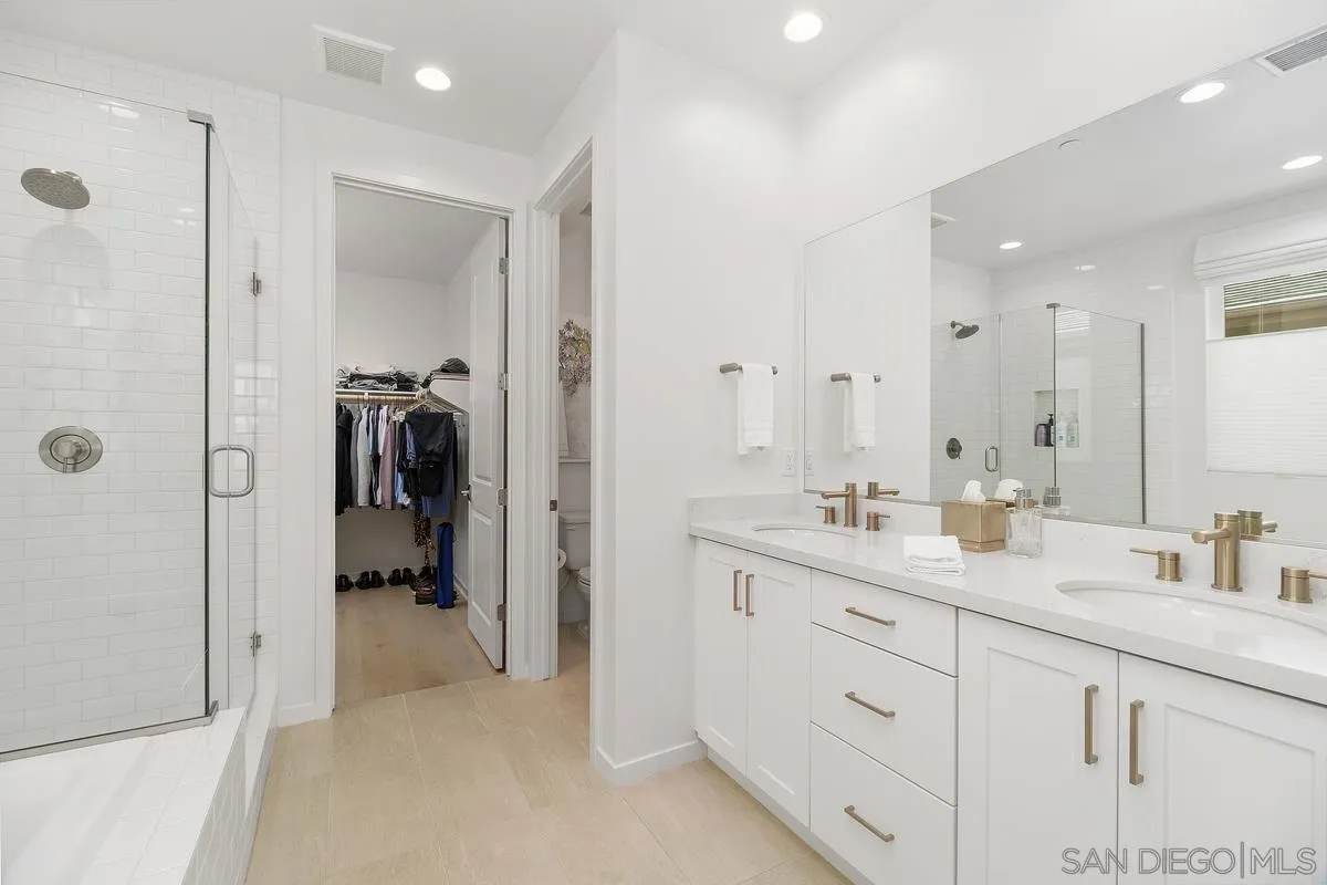 32082 Sedge Way Temecula, CA 92591 - Photo 17 of 59 a en suite bathroom with a granite countertop sink mirror and shower