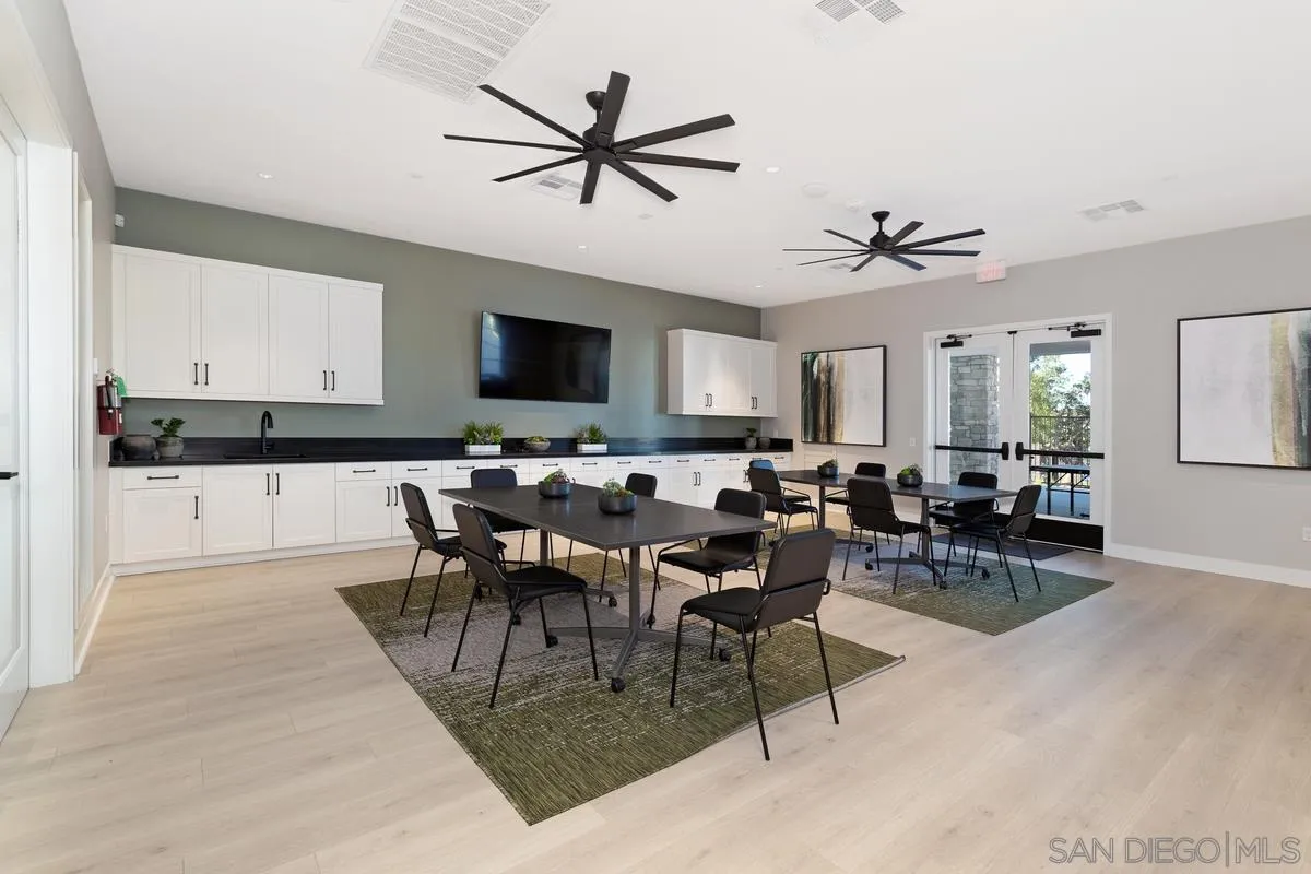 32082 Sedge Way Temecula, CA 92591 - Photo 46 of 59 a view of a dining room and livingroom with furniture a rug a fireplace and a window