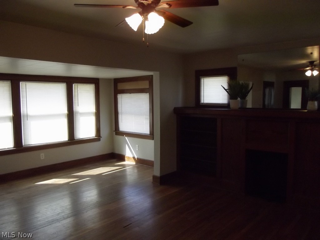 3363 Berea Road Cleveland, OH 44111 - Photo 13 of 50 Unfurnished living room with ceiling fan and dark hardwood / wood-style flooring