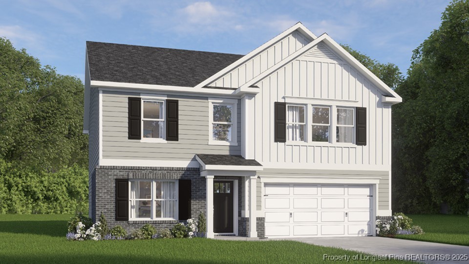 a front view of a house with a yard and garage