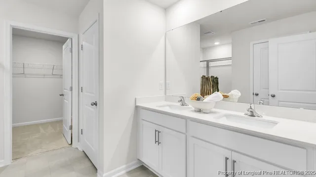 a bathroom with a double vanity sink and mirror