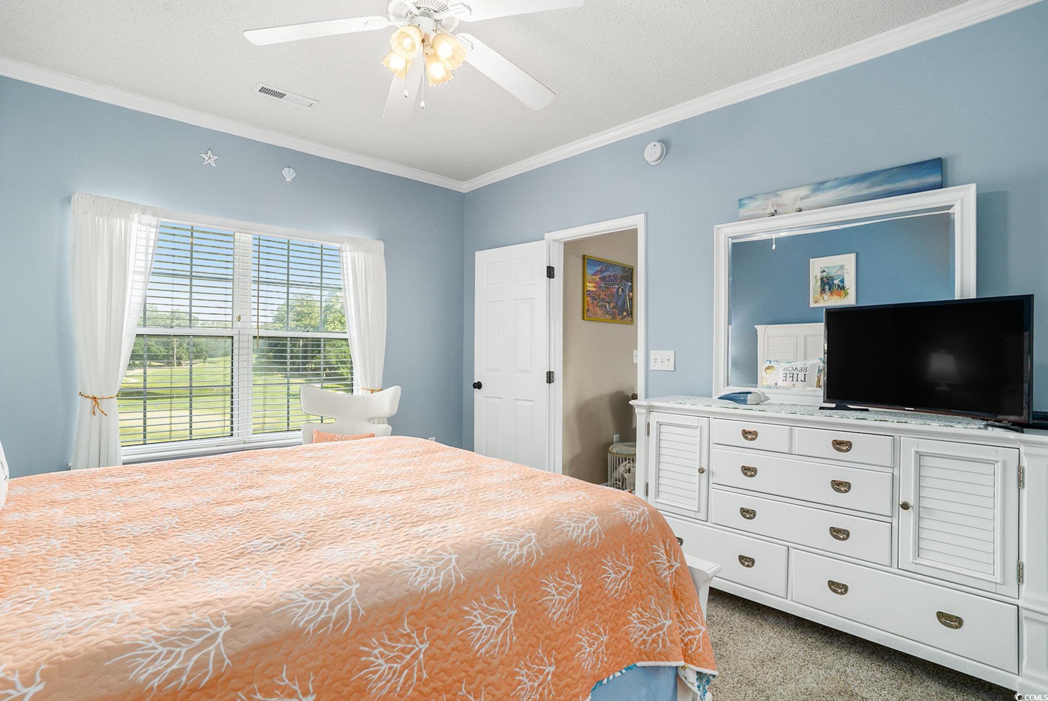 4459 Turtle Lane, Unit 3D Little River, SC 29566 - Photo 15 of 30 Carpeted bedroom featuring crown molding and ceiling fan