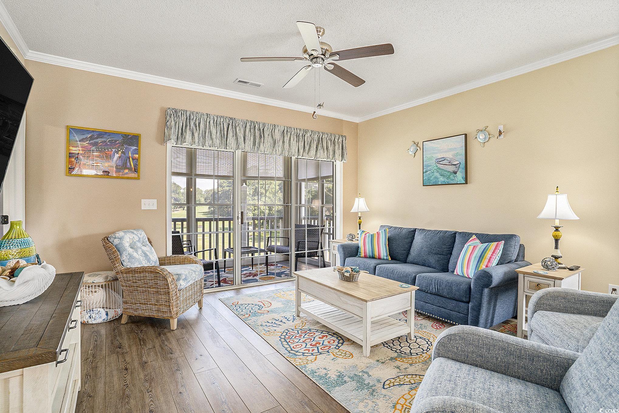 4459 Turtle Lane, Unit 3D Little River, SC 29566 - Photo 5 of 30 Living room with ornamental molding, hardwood / wood-style floors, a ceiling fan, and a textured ceiling
