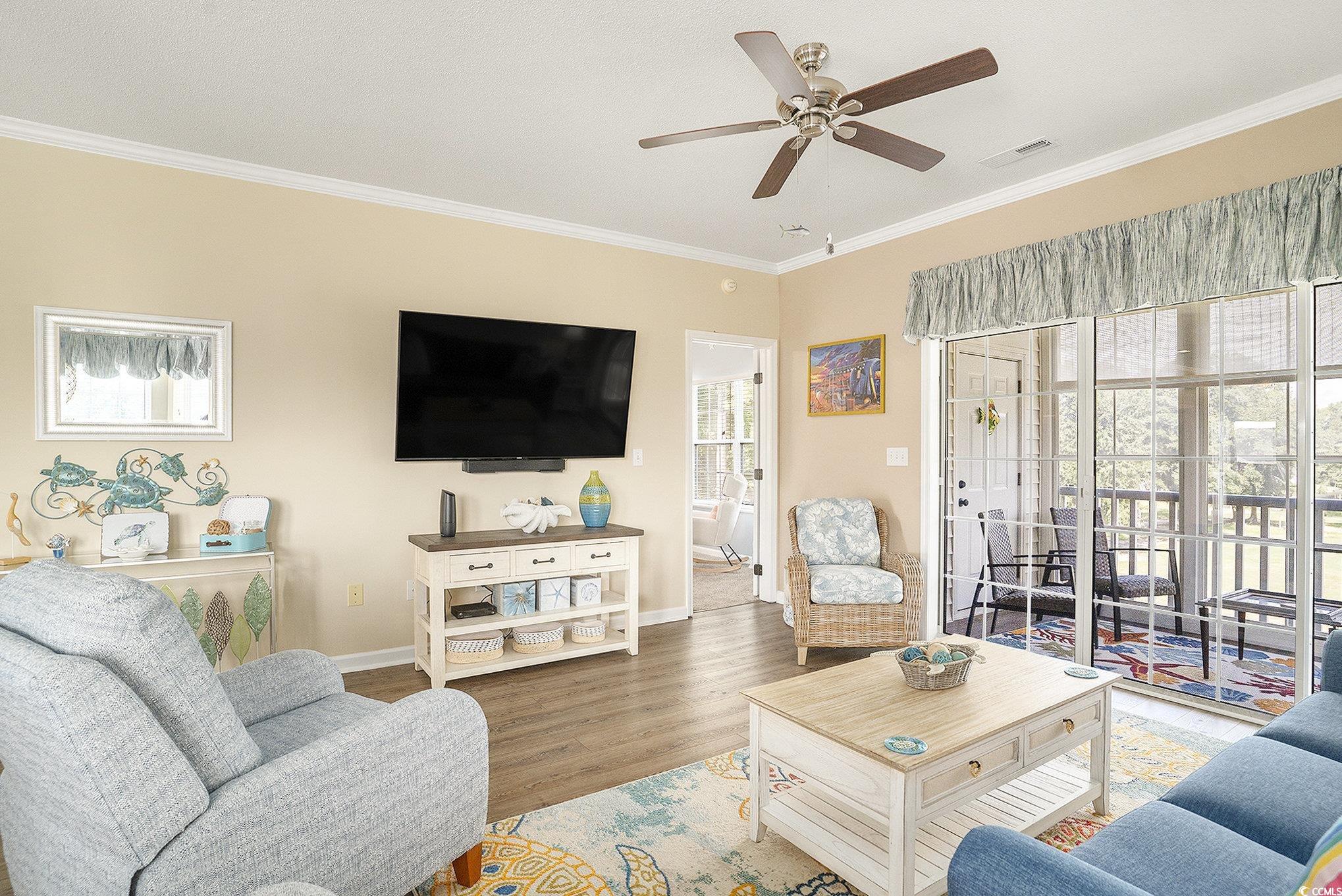4459 Turtle Lane, Unit 3D Little River, SC 29566 - Photo 6 of 30 Living room with crown molding, wood finished floors, and ceiling fan