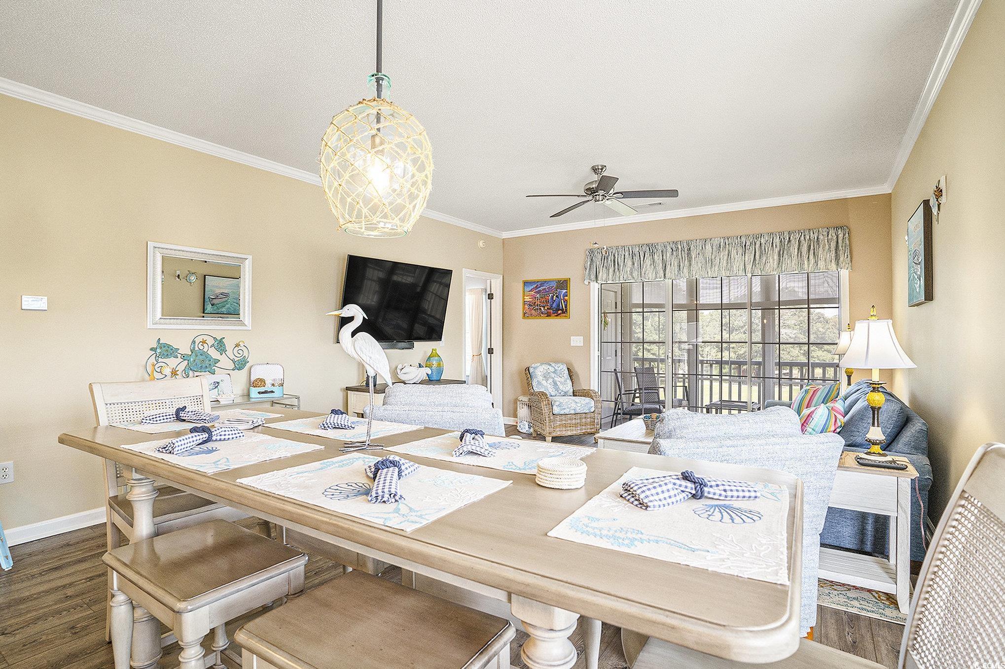 4459 Turtle Lane, Unit 3D Little River, SC 29566 - Photo 8 of 30 Dining space featuring ornamental molding, dark wood finished floors, and a ceiling fan