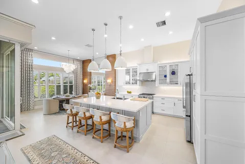 a hallway with wooden floor and a chandelier