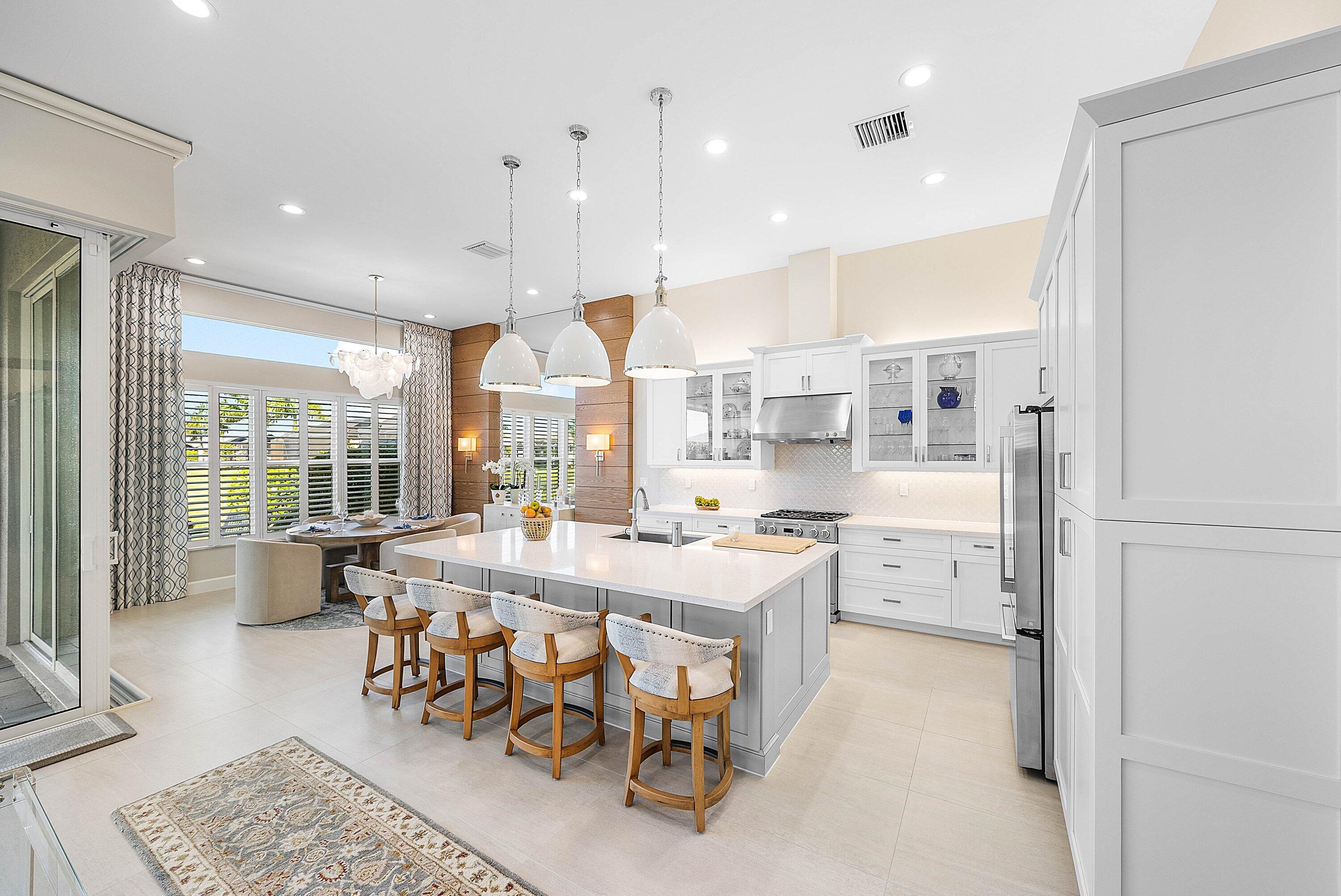 12626 Parrot Pond Road Boynton Beach, FL 33473 - Photo 12 of 67 a large kitchen with a table and chairs