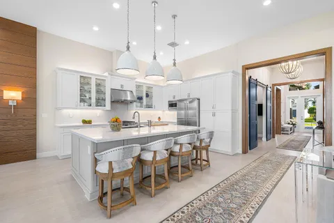 a large white kitchen with a large window