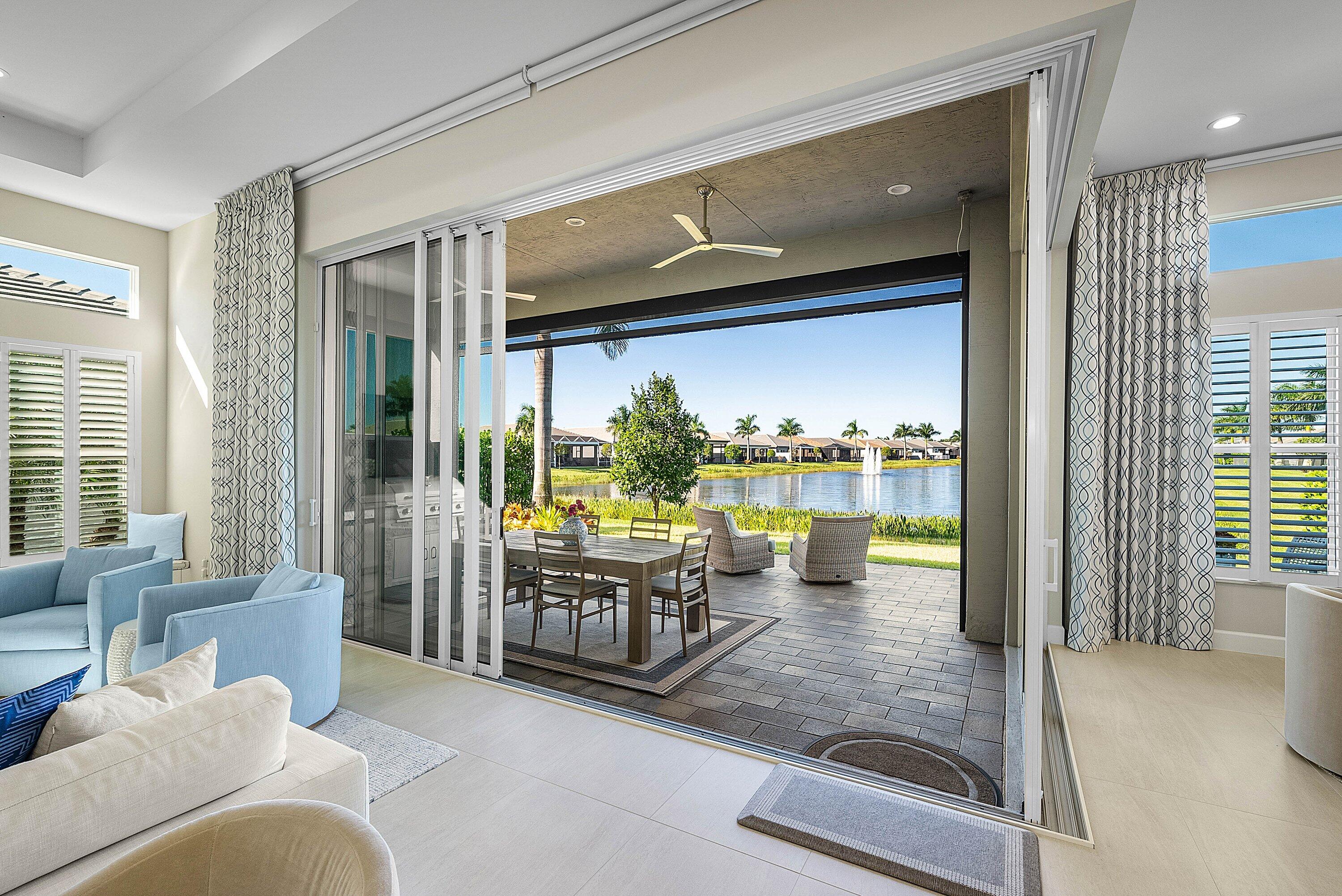 12626 Parrot Pond Road Boynton Beach, FL 33473 - Photo 22 of 67 a living room with furniture and a floor to ceiling window