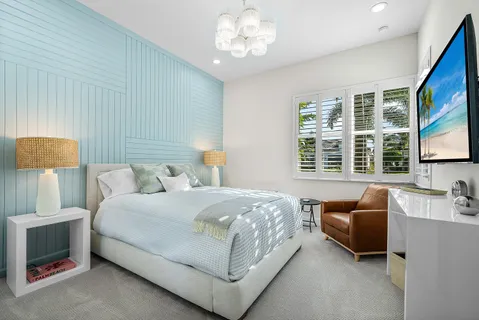 a bedroom with a bed and a chandelier