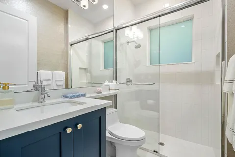 a bathroom with a shower sink double and mirror