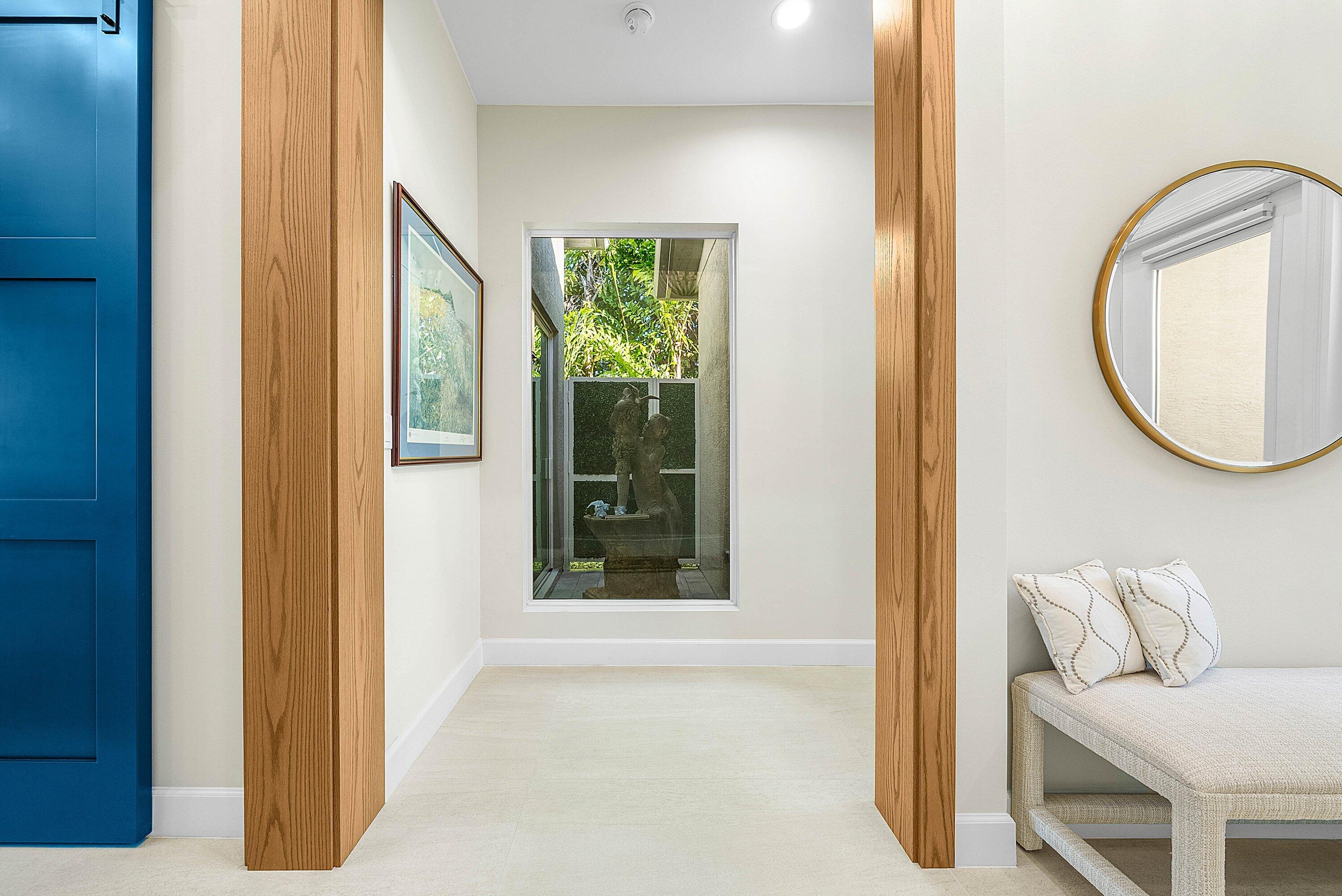 12626 Parrot Pond Road Boynton Beach, FL 33473 - Photo 25 of 67 a living room with a mirror and a window