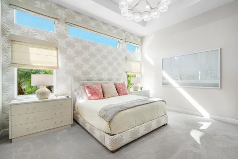 a bedroom with furniture and a chandelier