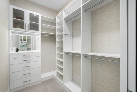 a aerial view of a house with a yard and lake view