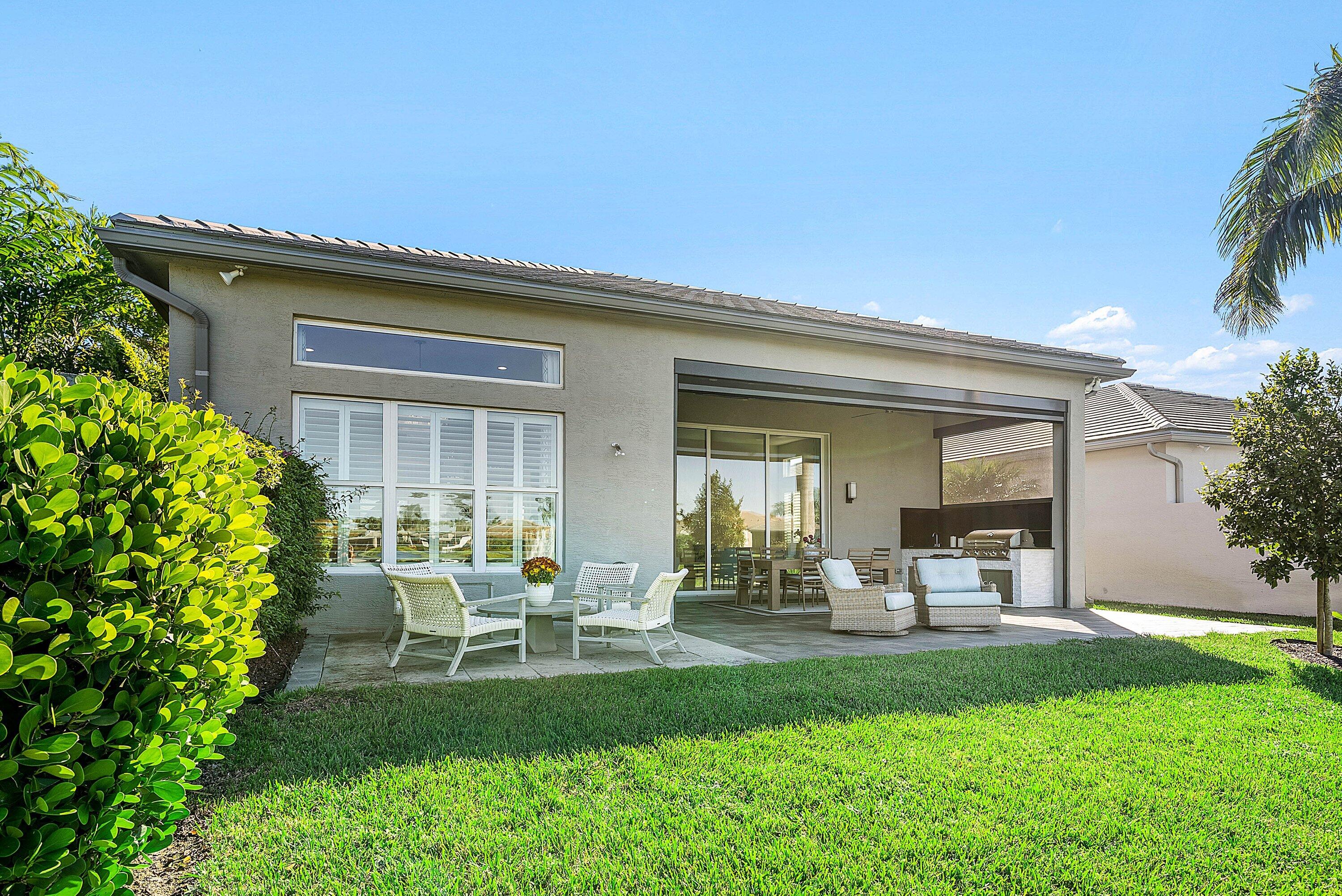 12626 Parrot Pond Road Boynton Beach, FL 33473 - Photo 44 of 67 a view of a chair and table in backyard of the house