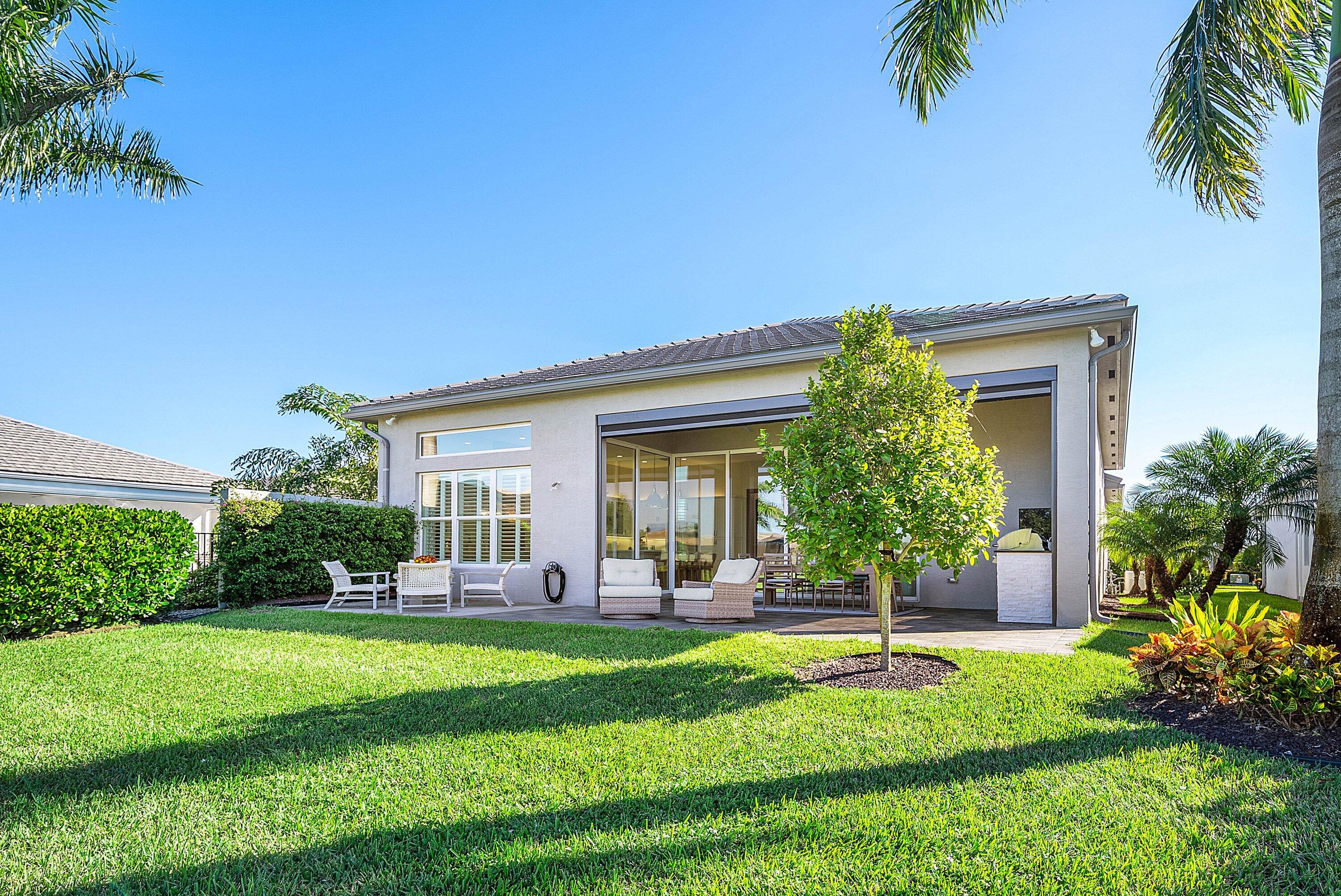 12626 Parrot Pond Road Boynton Beach, FL 33473 - Photo 45 of 67 a view of a house with a backyard
