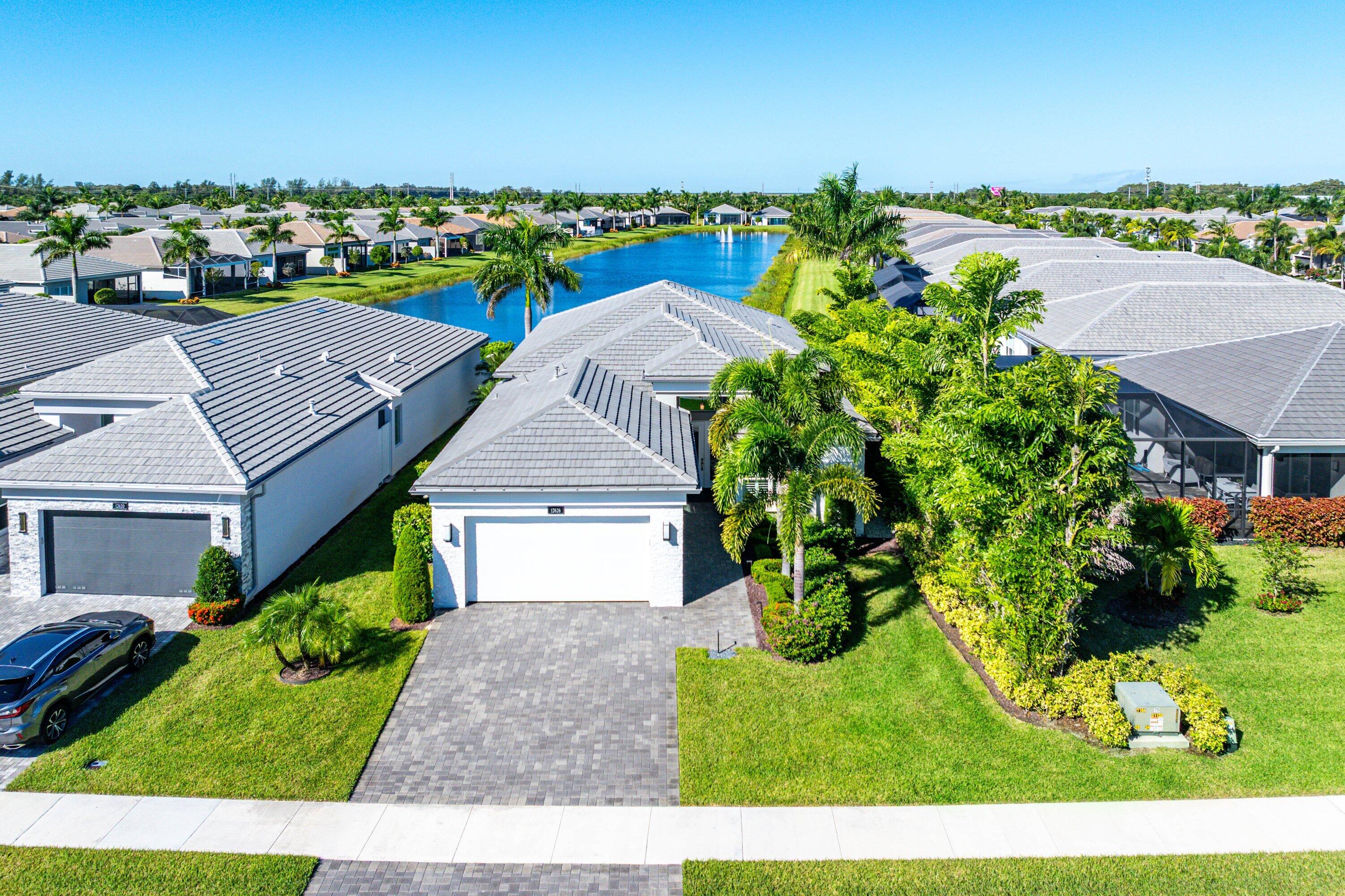 12626 Parrot Pond Road Boynton Beach, FL 33473 - Photo 47 of 67 a aerial view of a house with a yard and lake view