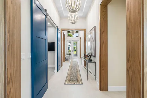 a living room with furniture a fireplace and a chandelier