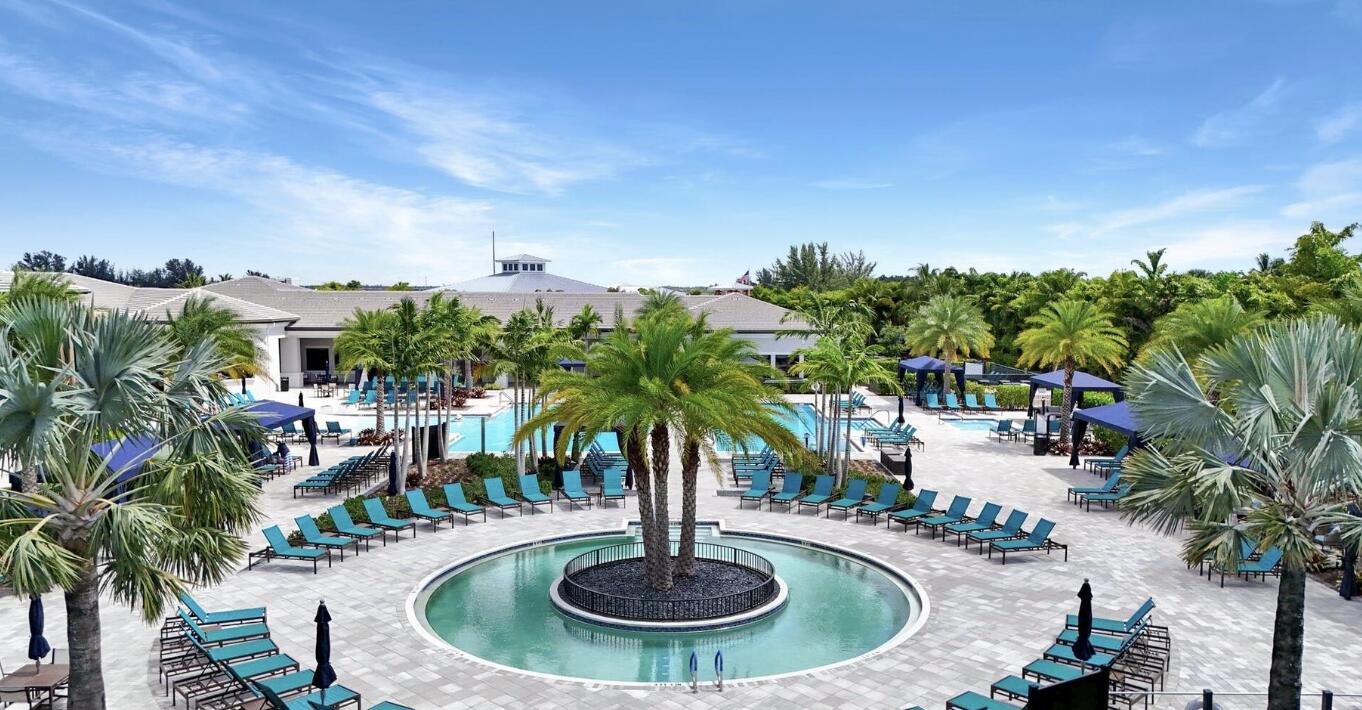 12626 Parrot Pond Road Boynton Beach, FL 33473 - Photo 65 of 67 a swimming pool with outdoor seating and plants