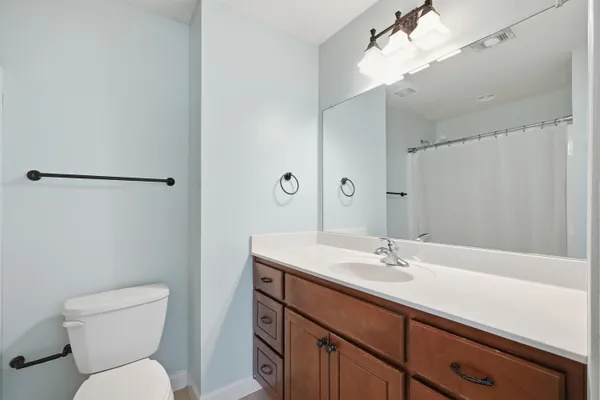 a white toilet sitting next to a shower