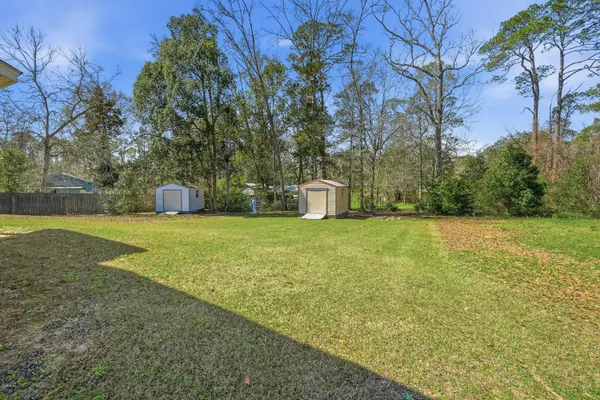 a big house with a big yard and large trees