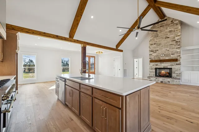 a view of a room with wooden floor and a bathroom