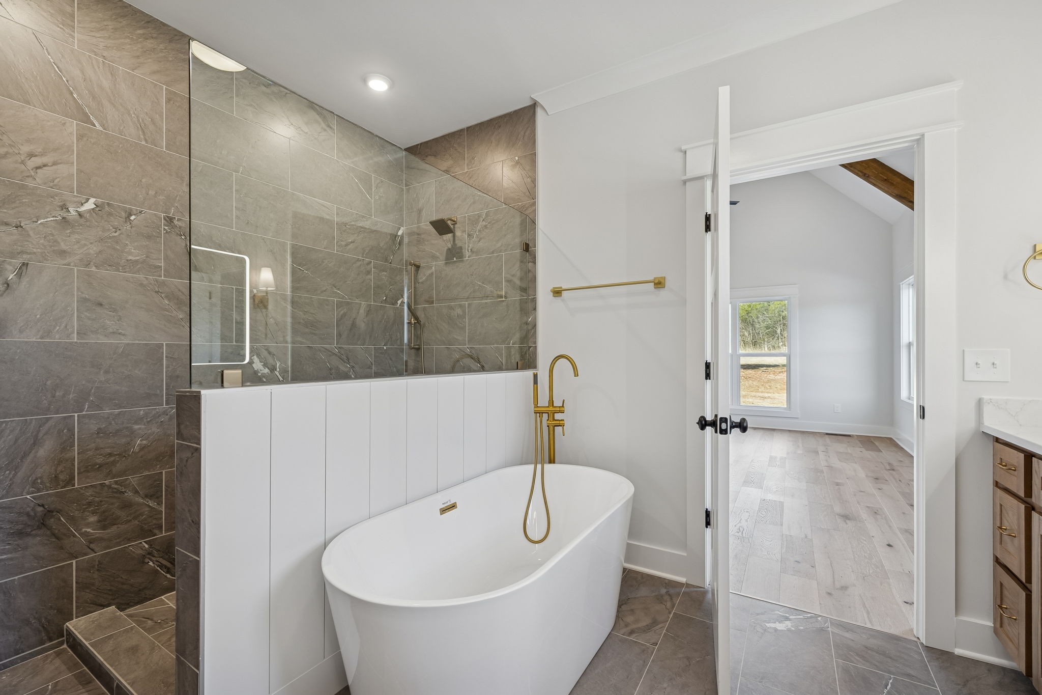 8533 Twelve Corners Road Lascassas, TN 37085 - Photo 37 of 79 a bathroom with a white bath tub a shower and a sink
