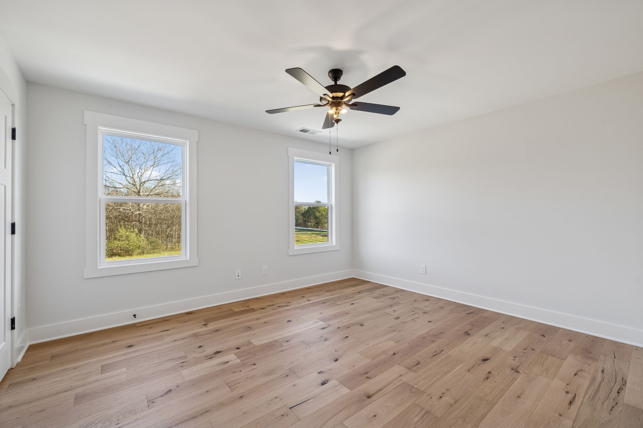8533 Twelve Corners Road Lascassas, TN 37085 - Photo 50 of 79 a view of an empty room with wooden floor and a window