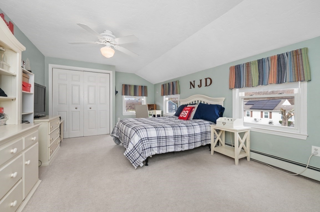 10 Shade Street Waltham, MA 02452 - Photo 16 of 33 a bedroom with a bed and a chandelier