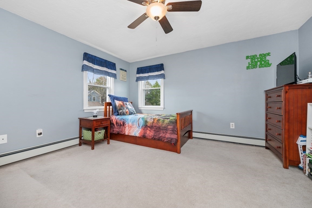 10 Shade Street Waltham, MA 02452 - Photo 17 of 33 a living room with furniture and a flat screen tv