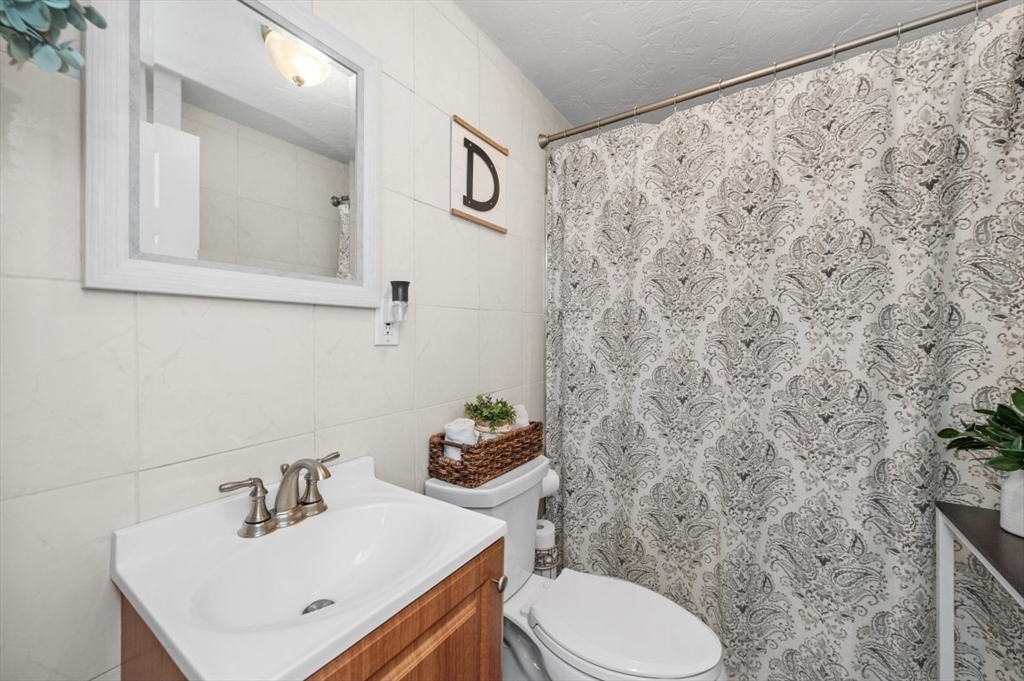 10 Shade Street Waltham, MA 02452 - Photo 19 of 33 a bathroom with a sink and a toilet