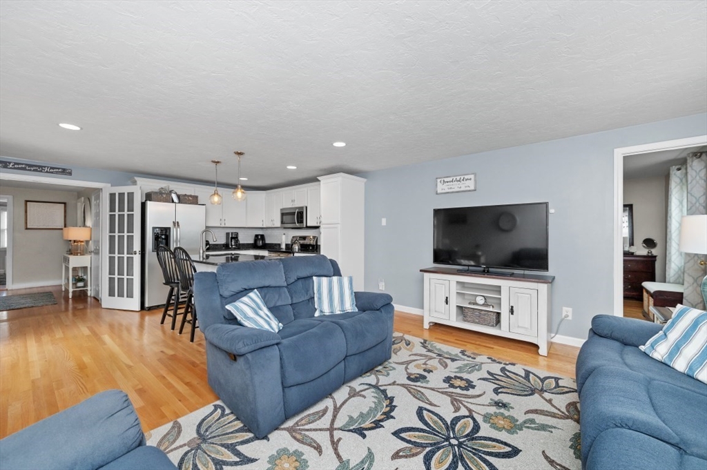 10 Shade Street Waltham, MA 02452 - Photo 25 of 33 a living room with furniture and a flat screen tv
