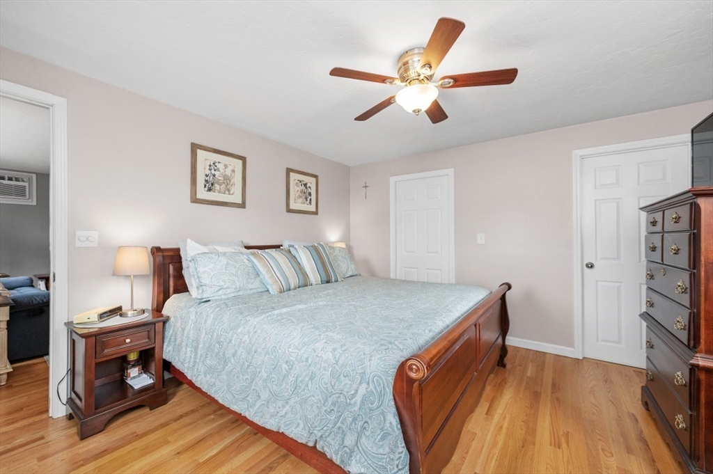 10 Shade Street Waltham, MA 02452 - Photo 26 of 33 a bedroom with a bed and a chandelier