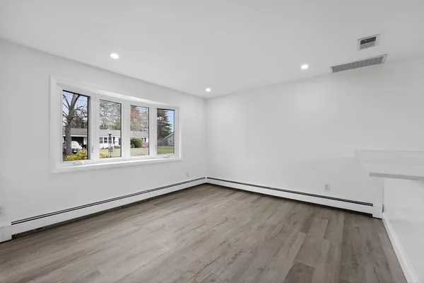 wooden floor in an empty room with a window