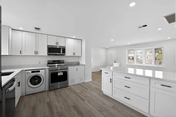 a kitchen with a stove a sink and a microwave