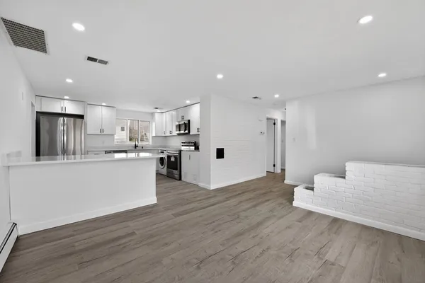 a view of kitchen with wooden floor