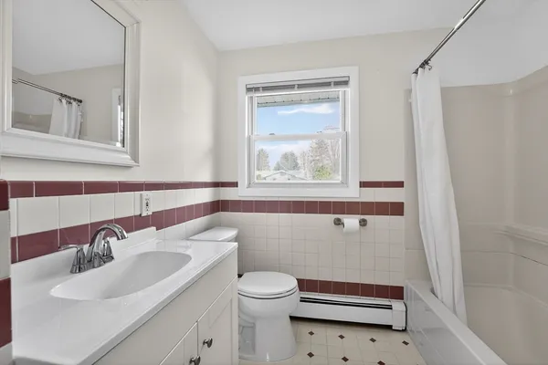 a bathroom with a sink a toilet and a mirror