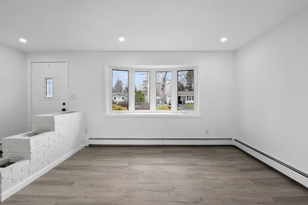 wooden floor in an empty room with a window