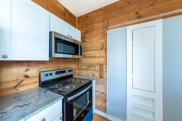 a kitchen with stainless steel appliances granite countertop a stove and a microwave