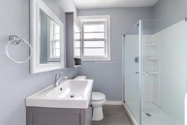 a bathroom with a sink toilet and shower