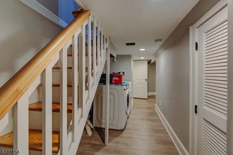 a view of entryway with wooden floor and stairs